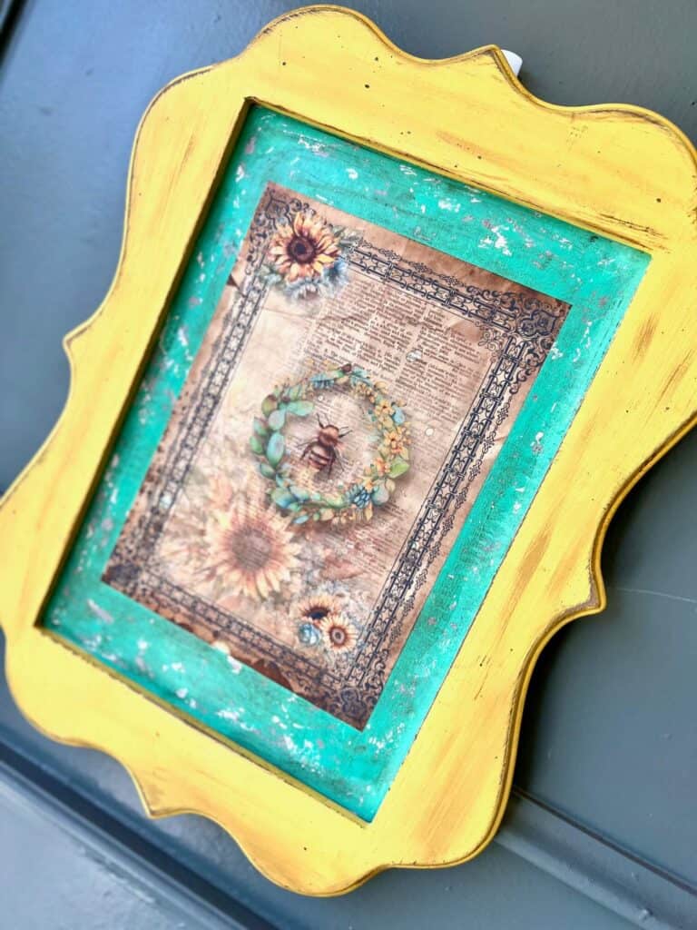 A yellow decor frame with a rice paper printable on the inside with teal border.
