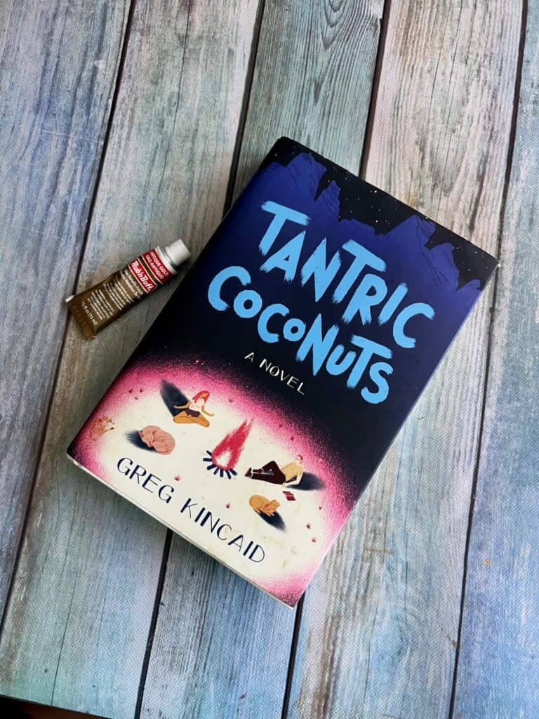 The thrift store book with the title "Tantric Coconuts" sitting on a table next to Antique Gold Rub n' Buff.