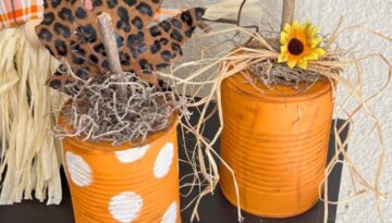 Easy and affordable recycled tin can pumpkin fall decor craft made with just a few cheap supplies a sunflower and a leopard print leaf.