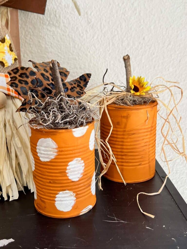 Easy and affordable recycled tin can pumpkin fall decor craft made with just a few cheap supplies a sunflower and a leopard print leaf.