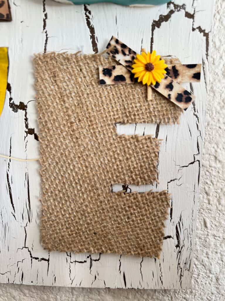 A burlap E with a small leopard print bow.
