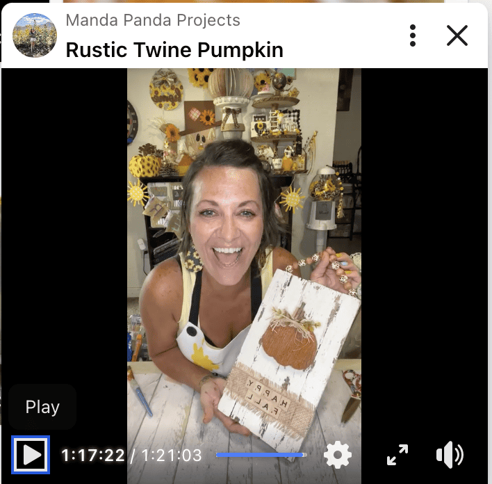 Amanda holding the completed craft on a facebook live thumbnail.