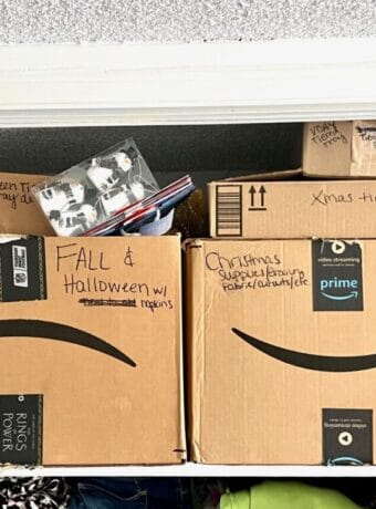 Cardboard boxes full of seasonal holiday decorations clearly labeled on the outside with black Sharpie.