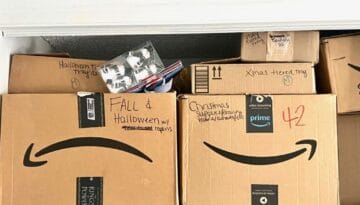 Cardboard boxes full of seasonal holiday decorations clearly labeled on the outside with black Sharpie.