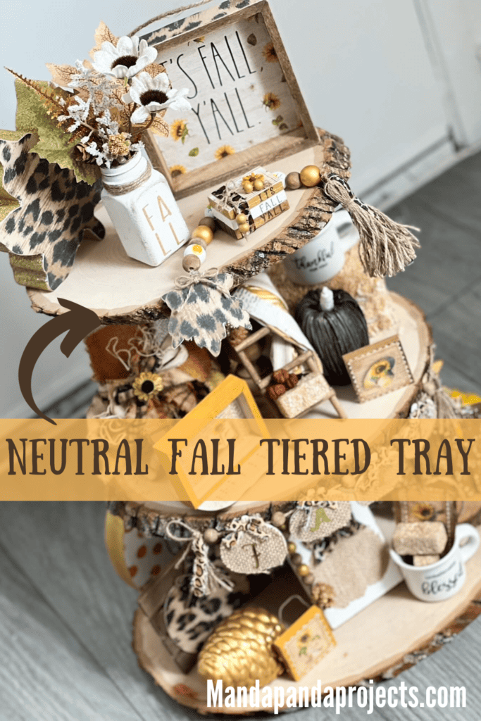 Neutral fall tiered tray with accents of leopard print, sunflowers, gold, and lots of pumpkins, acorns, pine cones, leaves, and other typical fall decor. Rustic handmade tiered tray with lots of handmade decor pieced on it to decorate for autumn and fall.