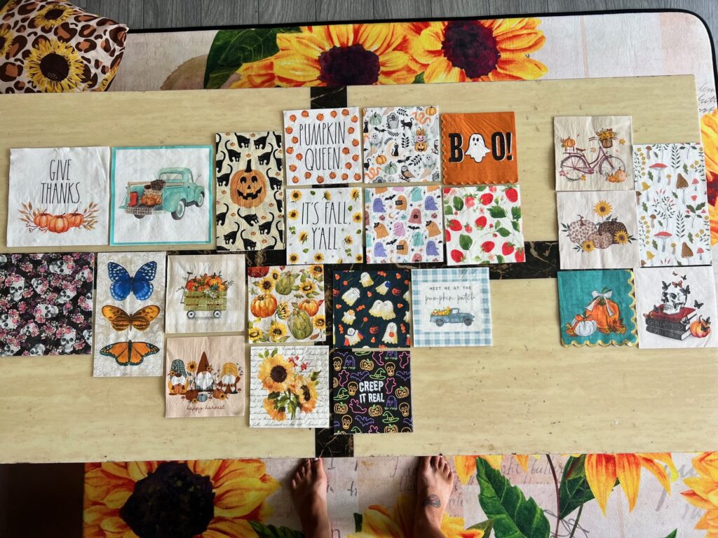 A bunch of fall and halloween cute napkins laid out on a table.