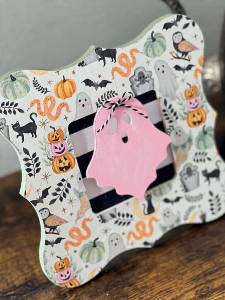 Dollar tree halloween wood pink ghost frame with a cute napkin on it.