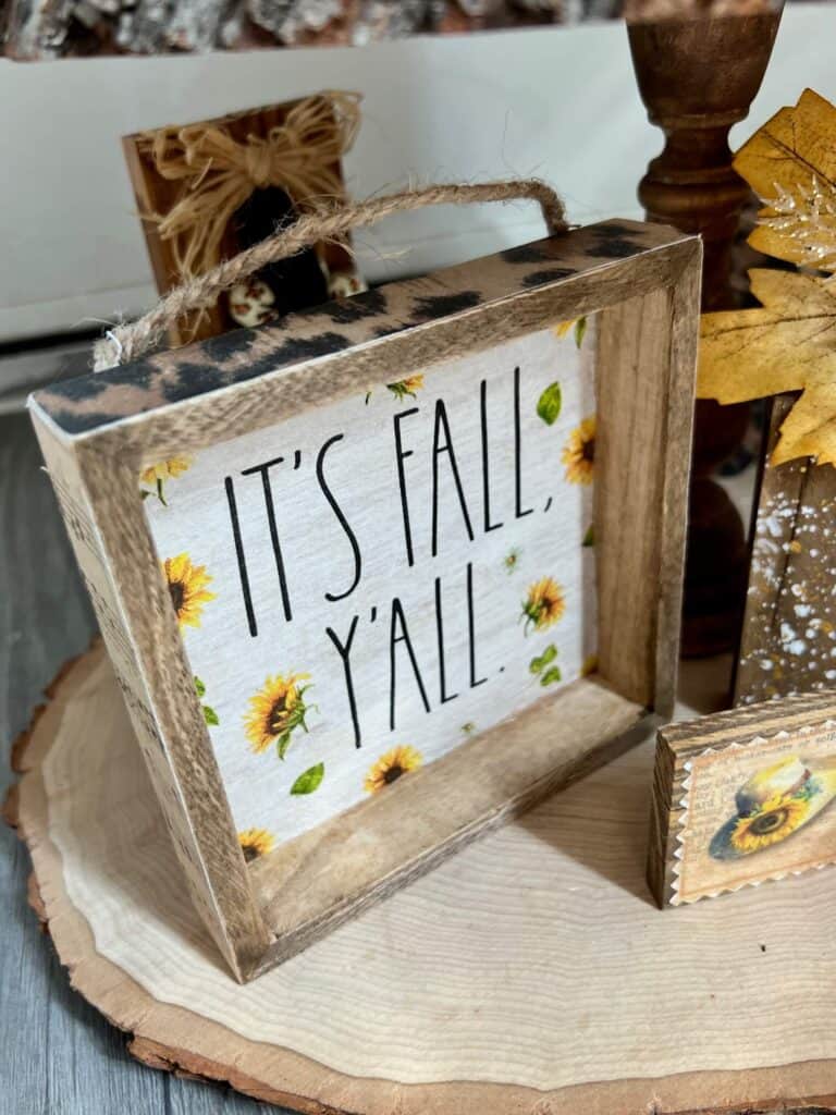It's Fall Y'all sunflower napkin box frame on a tiered tray with leopard print and music sheet sides.