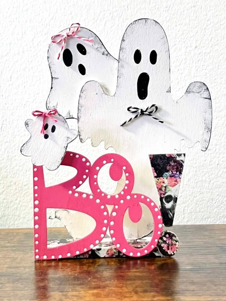 Dollar Tree Pink Boo Ghost shelf sitter with a floral pink and purple skull napkin.