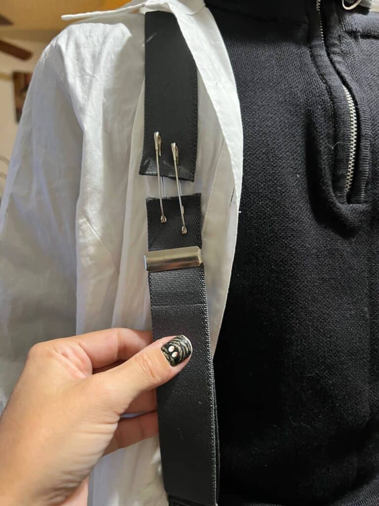 The suspenders cut in half and then held together with 2 safety pins.
