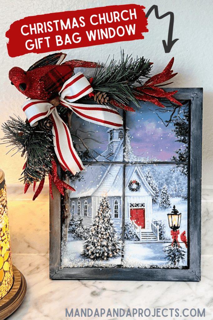 Christmas Church gift bag from walmart, turned into window winter scene with a reverse canvas and skewers, with greenery, a cardinal, and a bow in the corner. Easy DIY Christmas crafts and decor.