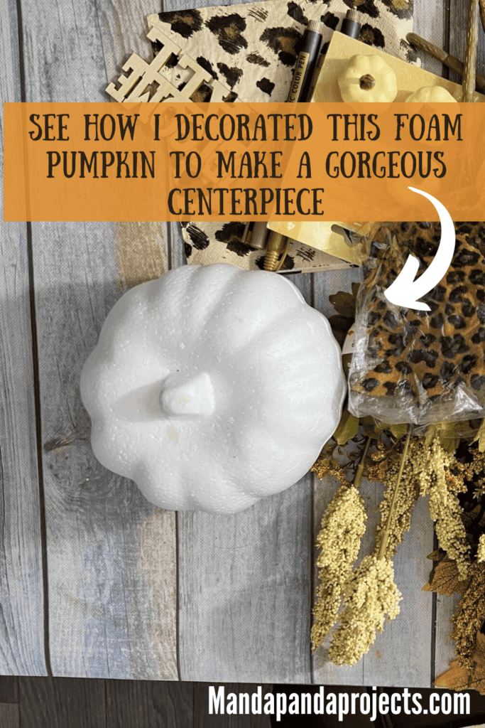 A dollar tree foam pumpkin painted white with gold lines, with neutral fall florals coming out the top and a "hello fall" pick, for a gorgeous and affordable thanksgiving table centerpiece and decor.