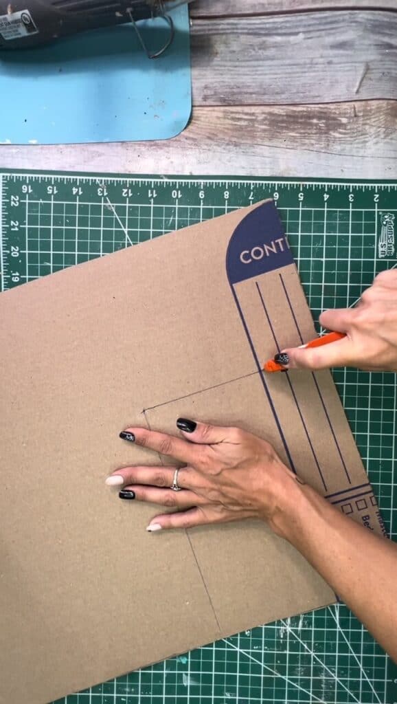 Cutting the cardboard background with an X-Acto knife.