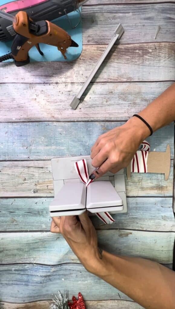 Make a simple shoestring bow in the bowdabra with red and white ribbon.