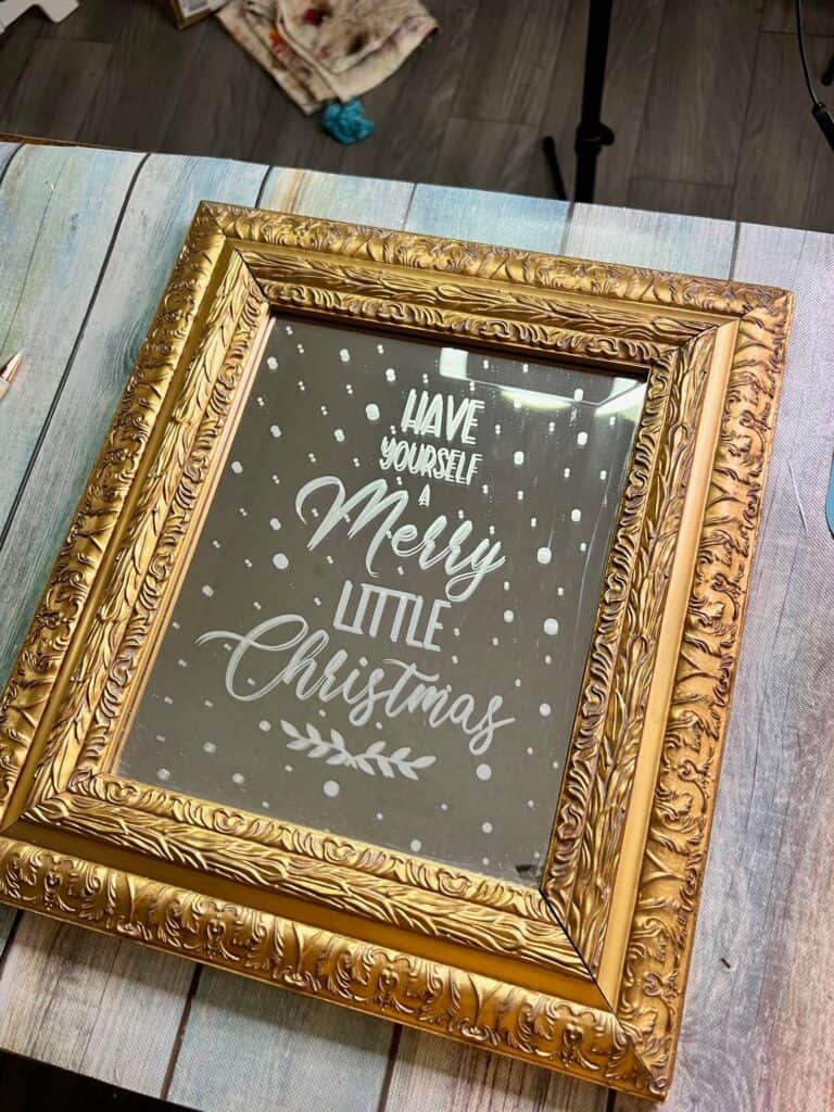 The completed upcycled mirror with "Have yourself a merry little christmas" etched into the mirror.
