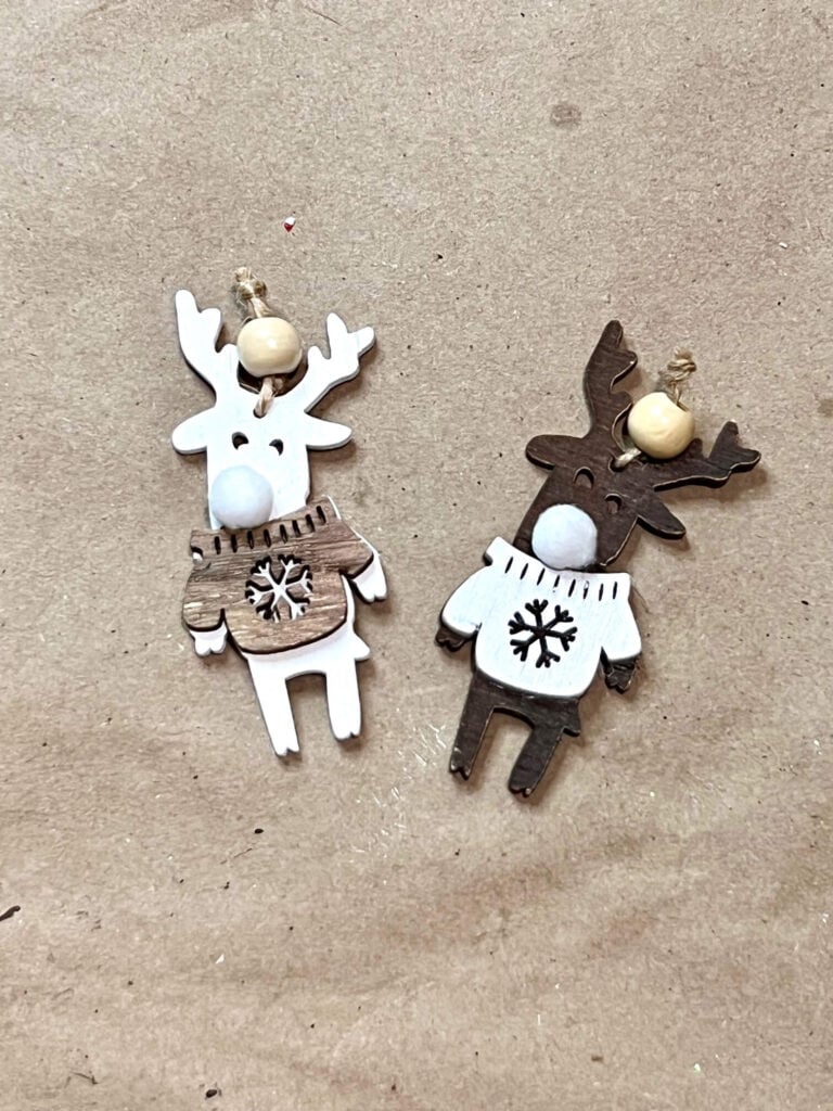 2 tan and brown neutral reindeer ornaments with white pom pom noses. A neutral version of rudolph the red-nosed reindeer.