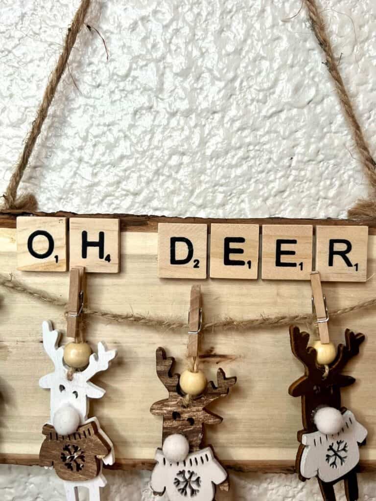 Close up showing the scrabble tiles that say "OH DEER" across the top of the ornament.