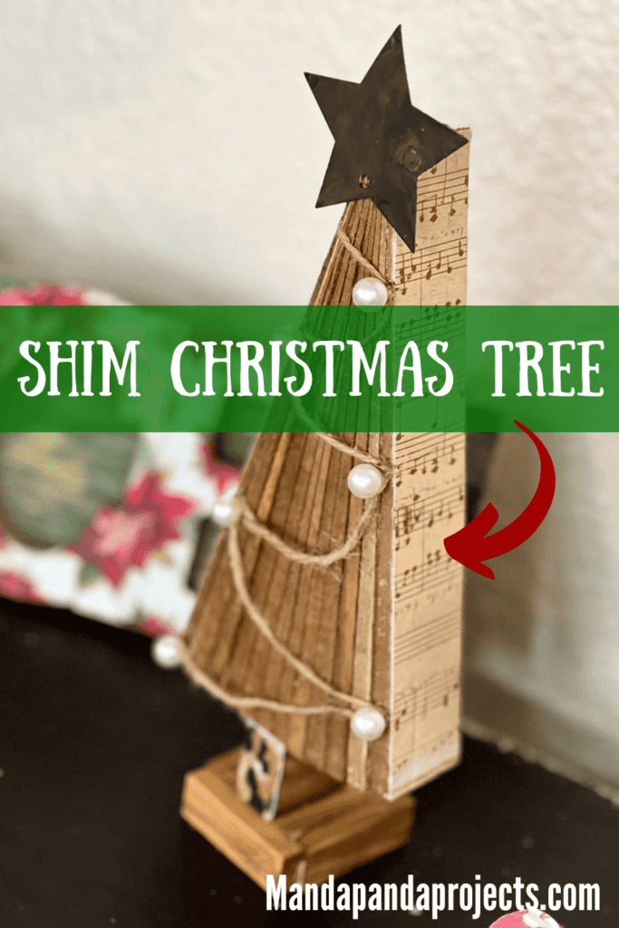 DIY standing Christmas tree decor with wooden shims, music sheet scrapbook paper, twine and pearls ornaments, a metal star and a leopard print trunk and stand made with jenga blocks.