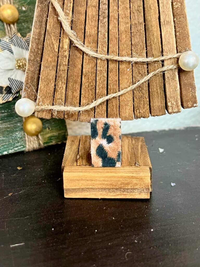 The base of the tree made with Jenga blocks, with a leopard print tree trunk.
