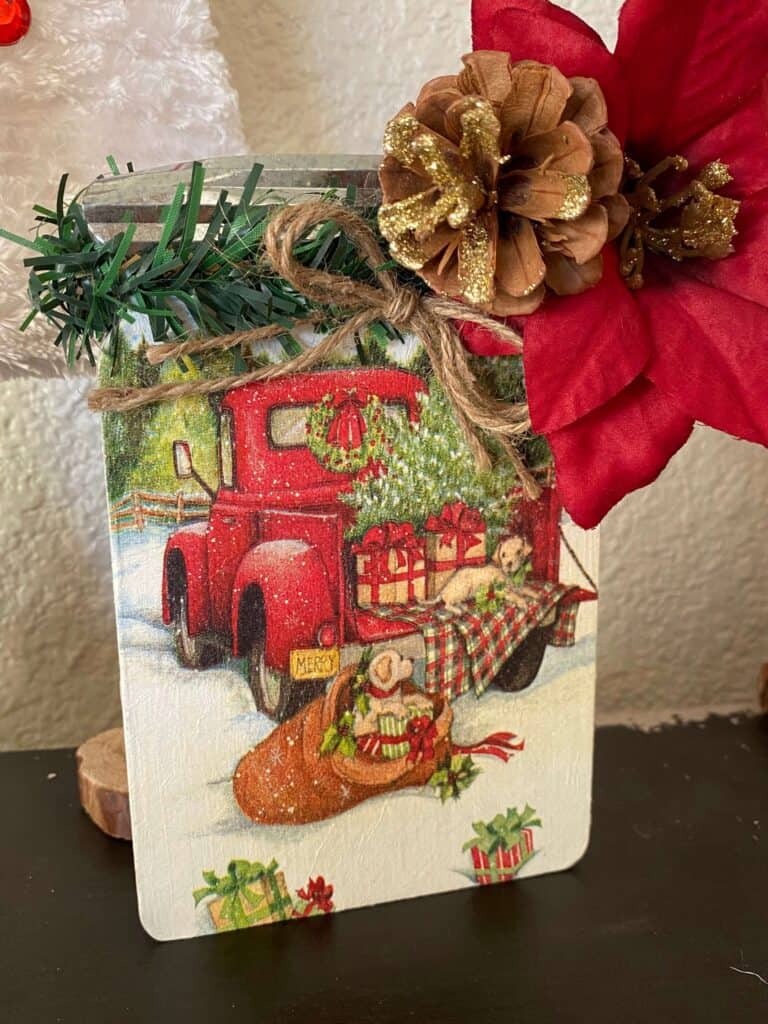 Close up of the Christmas red truck napkin decoupaged to the Wood Mason Jar.