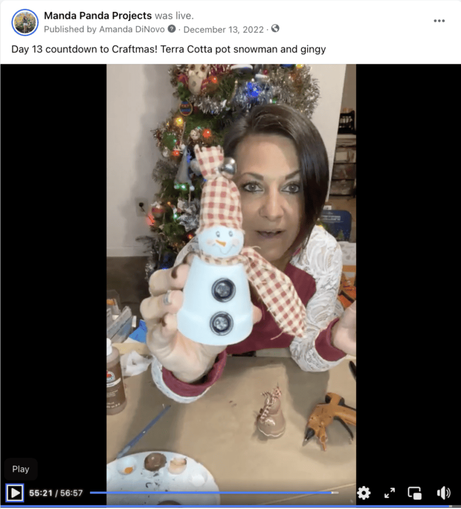 Amanda holding the completed snowman on a facebook live thumbnail.