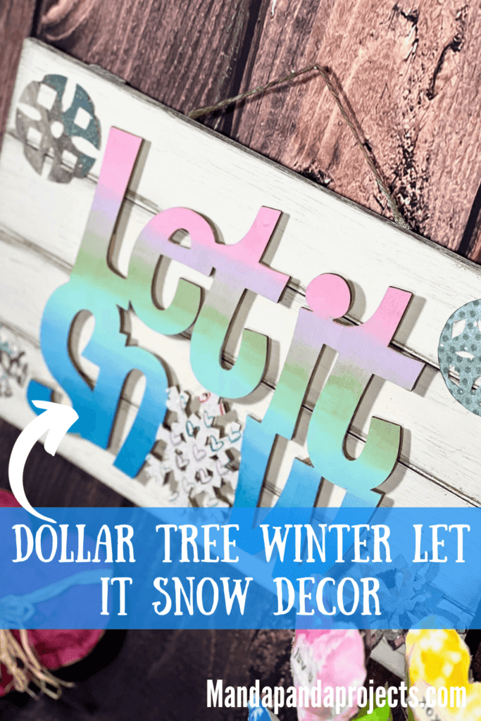 Dollar Tree Let it Snow Winter Decor with the words being a pastel ombre, a white wood pallet background and colorful sparkly snowflakes. The "O" in snow is a snowflake.
