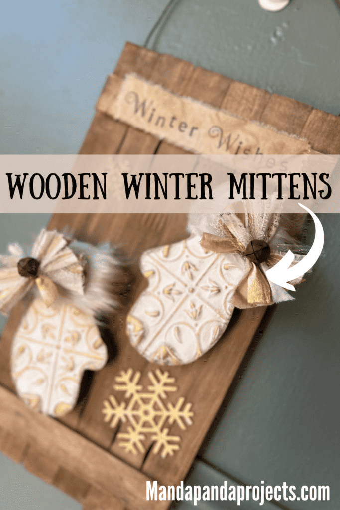 Wooden Winter Mittens Decor on a stained paint stick background, white and gold mittens with grungy faux fur, a small bow on the cuff of each, gold snowflakes, and the top says "Winter Wishes".