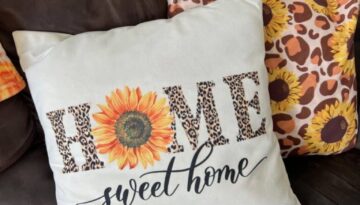 Throw pillow that says HOME sweet home with leopard print letters the the O is a sunflower.