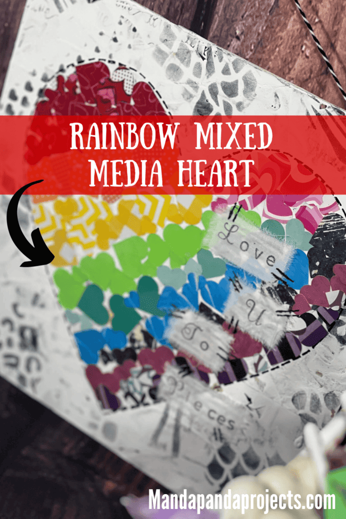 Mixed media rainbow heart made up of mini hearts.