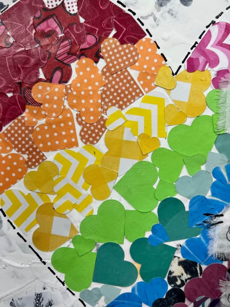 The big heart in the center is made up of tons of smaller scrapbook paper hearts in lots of rainbow colors.