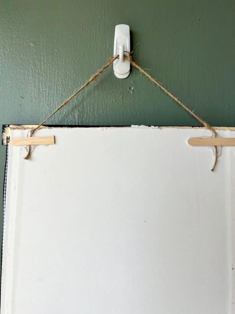 The back of the calendar frame showing it hanging with twine.