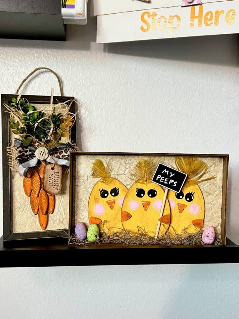 My Peeps Wood Egg Chicks Shelf Sitter made with Dollar Tree Wood Easter Eggs, a frame, some mini eggs, and a sign that says "My Peeps". 3 egg shaped yellow chicks with yellow feathers.
