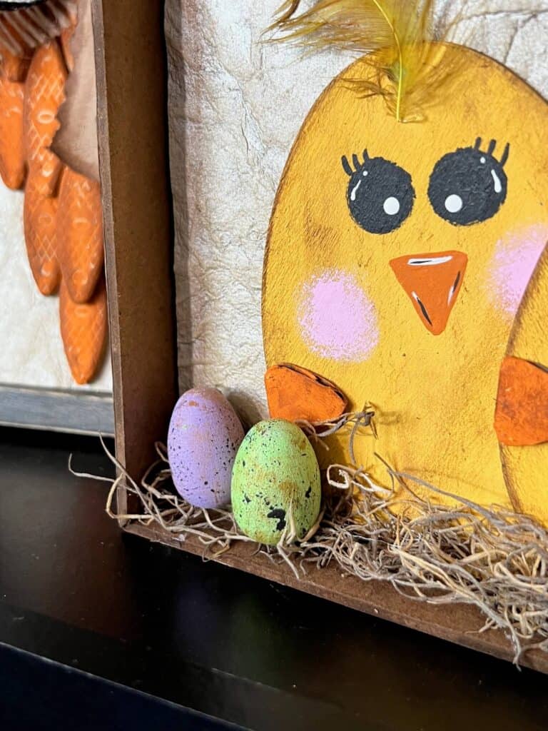 Close up of the small wood easter eggs at the bottom of the frame laying on the spanish moss.