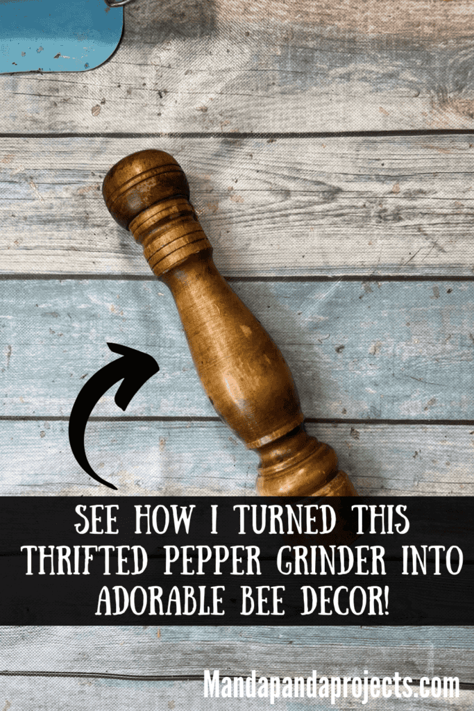 Wooden thrift store pepper grinder sitting on a table.
