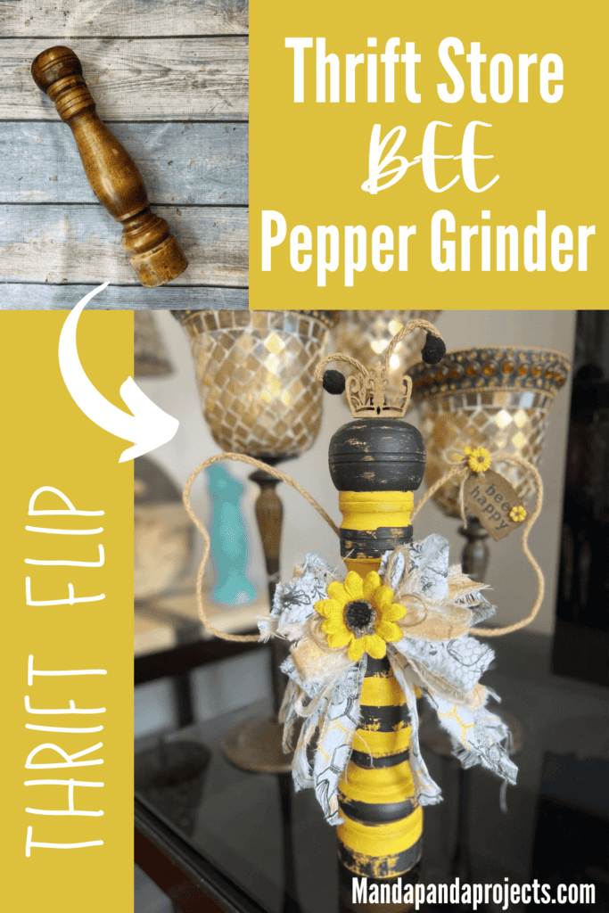 Thrift Store Pepper Grinder Queen Bee made from a thrifted wooden pepper grinder yellow with black stripes, wired jute wings with a small tag with sunflowers that says "bee happy", a mini gold crown, and a big messy fabric bow.
