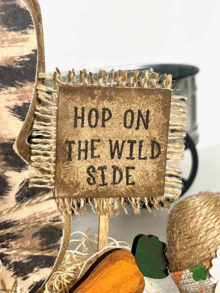 A small sign with burlap that says "Hop on the wild side".