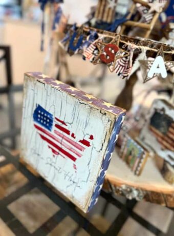 DIY patriotic Tiered Tray Shelf sitter with a Home Sweet Home american flag USA napkin decoupaged onto a small Dollar Tree box frame with crackle underneath and blue star scrapbook paper around the outer edges.