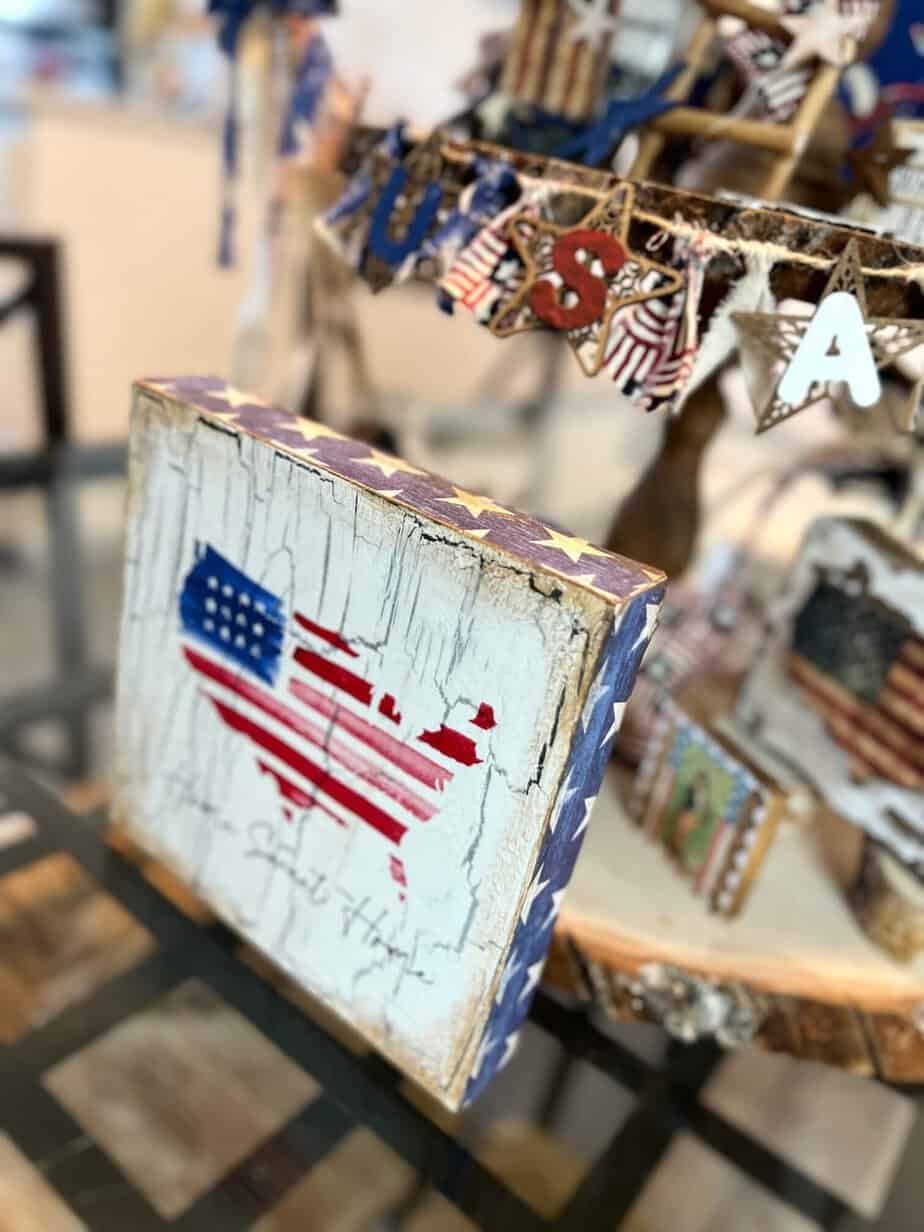 DIY patriotic Tiered Tray Shelf sitter with a Home Sweet Home american flag USA napkin decoupaged onto a small Dollar Tree box frame with crackle underneath and blue star scrapbook paper around the outer edges.