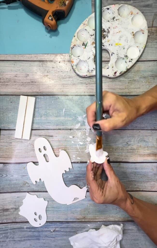 Painting the small wood ghost white.