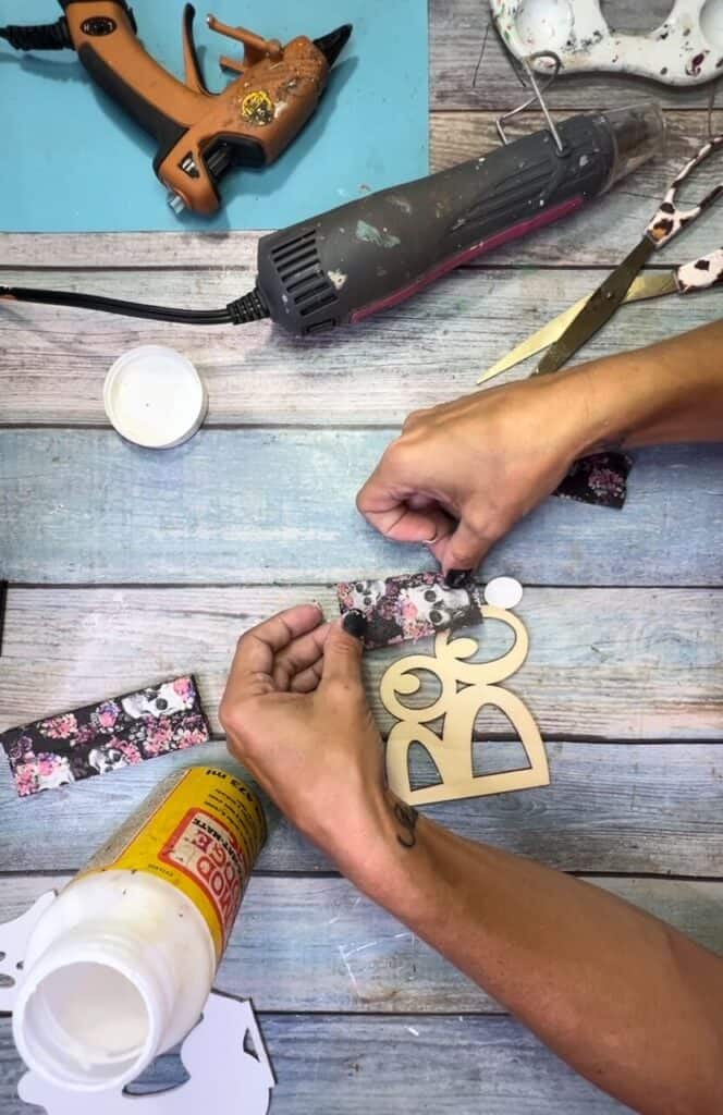 Mod Podge the floral skull napkin to the top of the exclamation point in the word BOO!