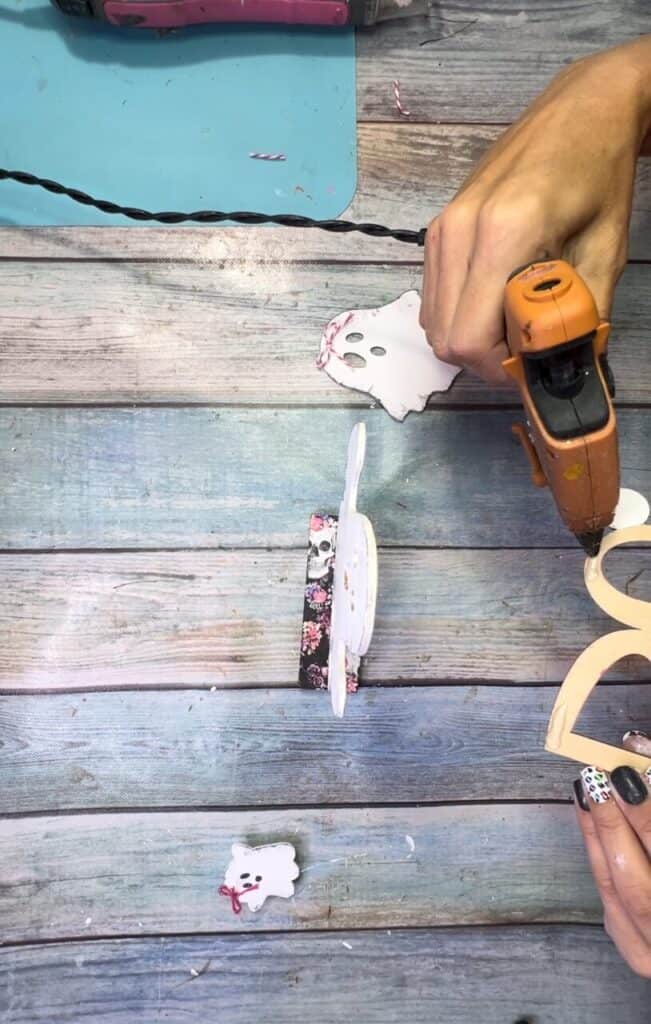 Gluing the wood ghost and the word BOO to the base.