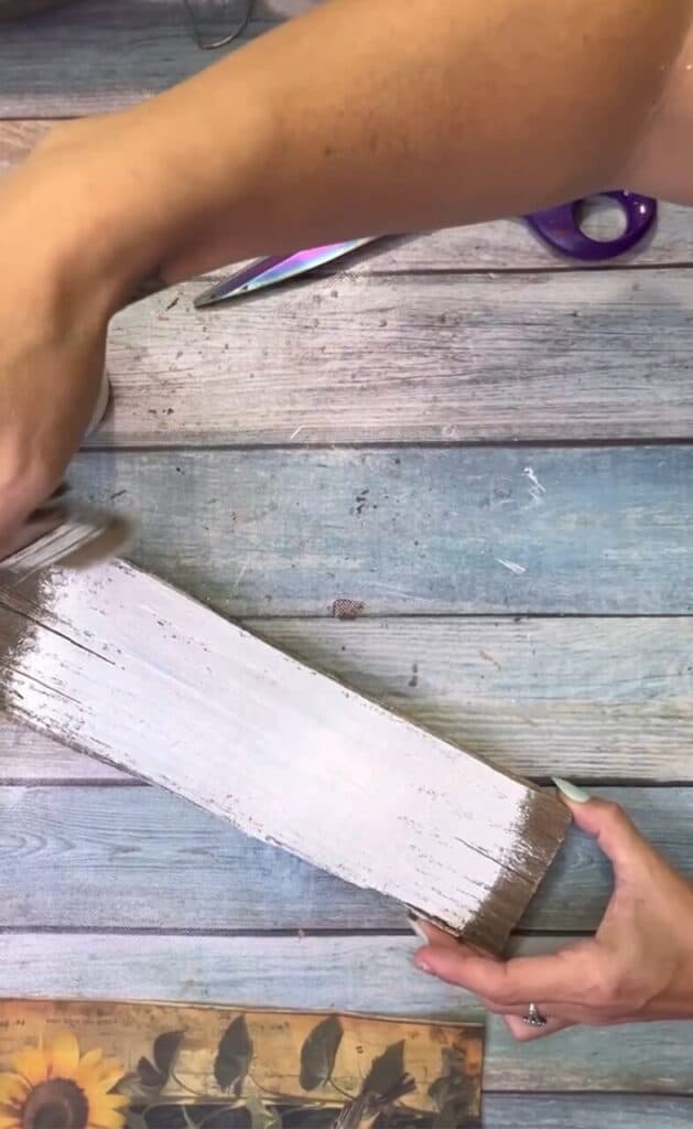 Paint the center of the scrap wood with white paint.