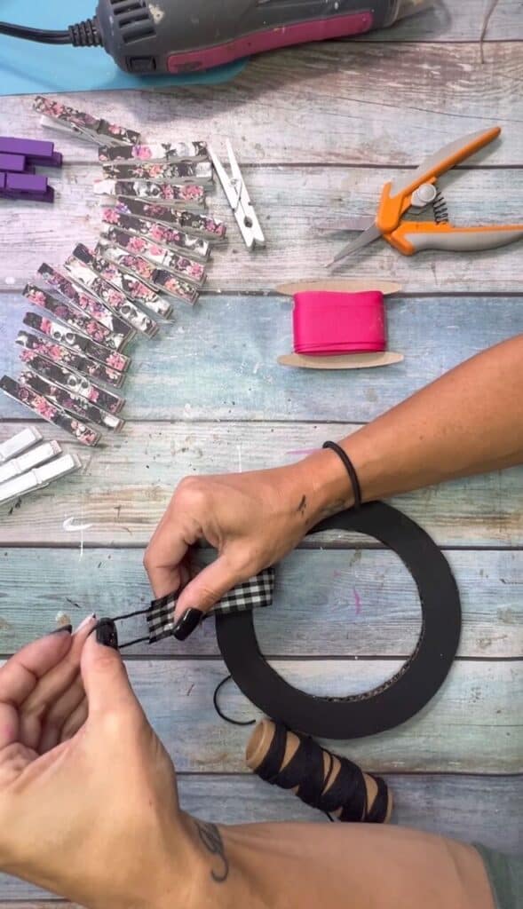 Making a small bakers twine loop at the top to hang the DIY Halloween Clothespin wreath.