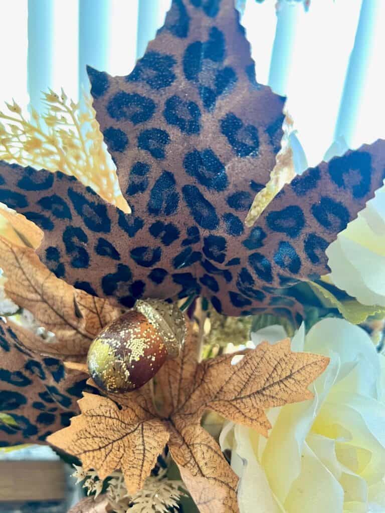 A leopard print fall leave pick in the floral arrangement.