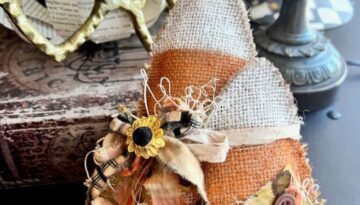 Fall and Halloween yellow, orange, and white candy corn made with burlap, 2 candy corn tied together with muslin and fabric bow with a sunflower embellishment to decorate your home.