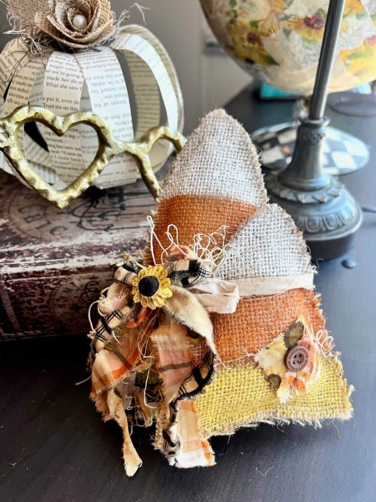 Fall and Halloween yellow, orange, and white candy corn made with burlap, 2 candy corn tied together with muslin and fabric bow with a sunflower embellishment to decorate your home.