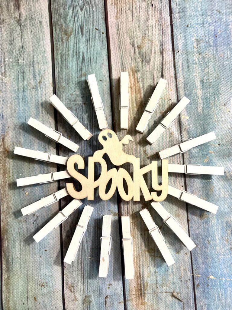 The outline of the project before it is painted decoupaged and completed. The clothespins are arranged around the "spooky" ghost.