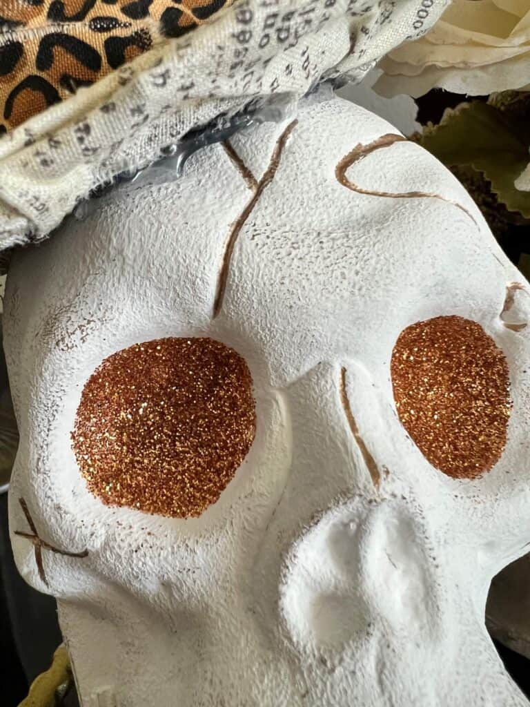 The skulls eyes are covered with copper gold glitter.