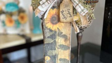 DIY Scrap wood sunflower decor with a free sunflower printable on rice paper, decoupaged onto a piece of scrap wood and a big messy fabric bow with a hangtag that says "enjoy the little things".