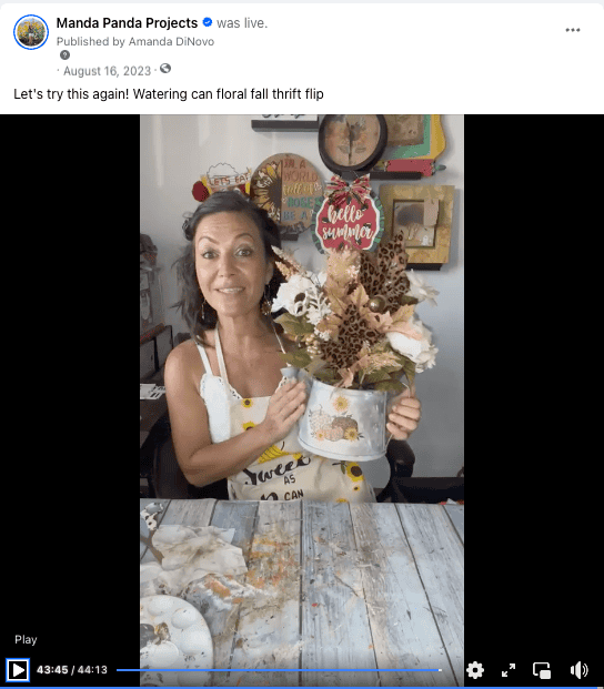 Amanda holding the completed watering can decor on a Facebook live thumbnail.